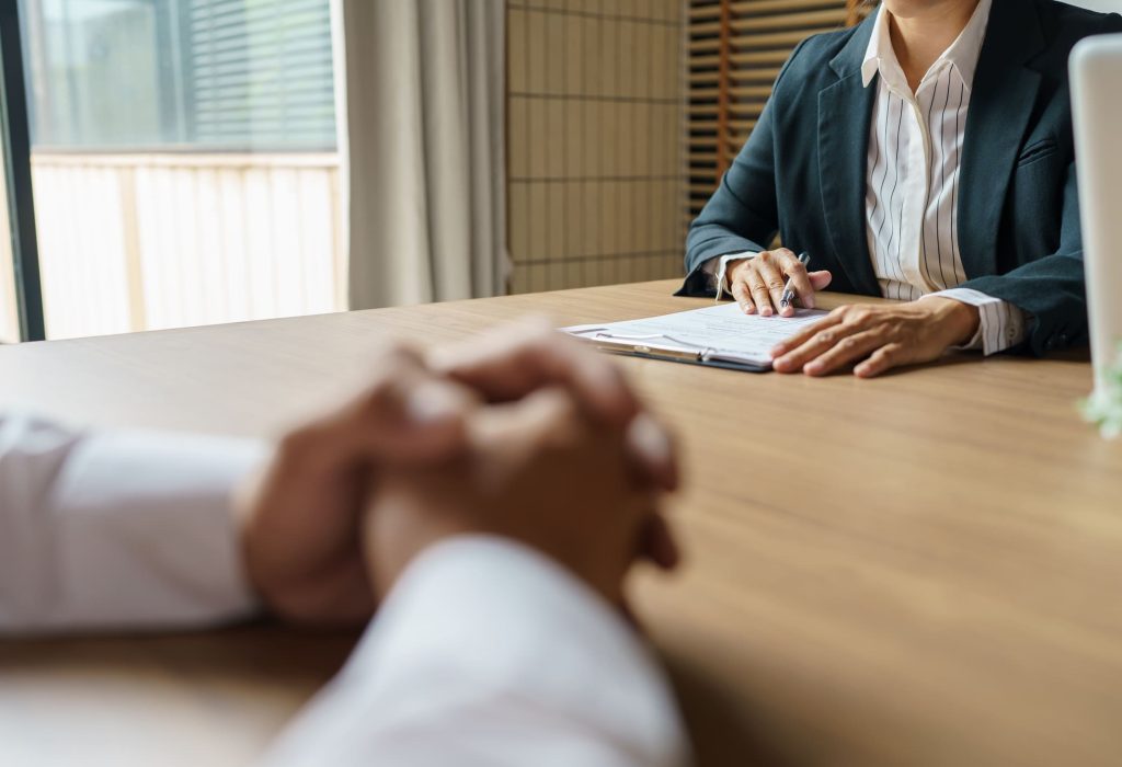 Examiner reading a resume during job interview at office Business and human resources concept.